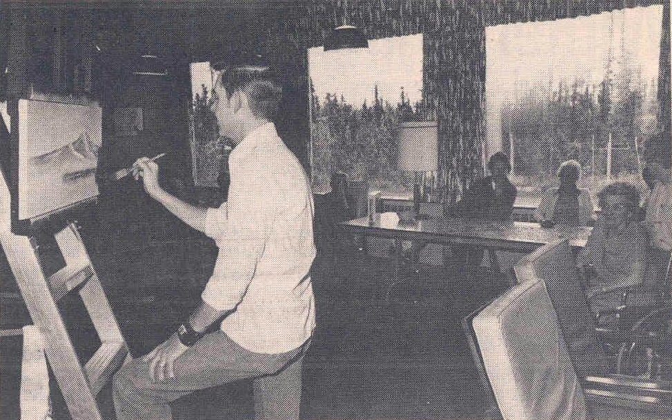 Bob Ross, then a US Air Force master sergeant, putting the finishing touch on a landscape painting during an art demonstration at the Fairbanks Pioneers Home in Alaska in the late 1970s, watched by two onlookers.