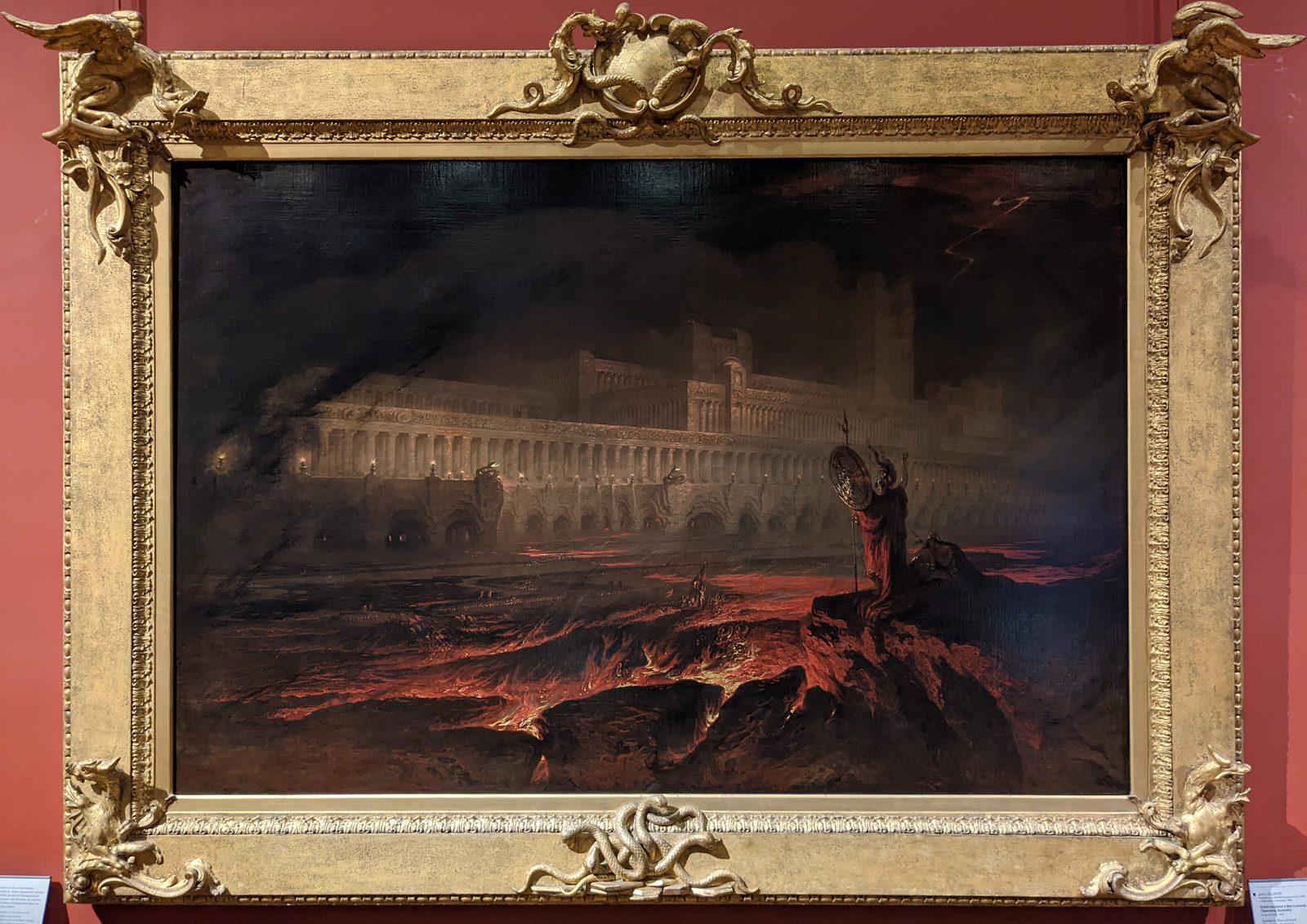 John Martin's Pandemonium as it hangs at the Louvre, showing the wide gilt frame he designed himself, carved with serpents and dragons around the canvas.