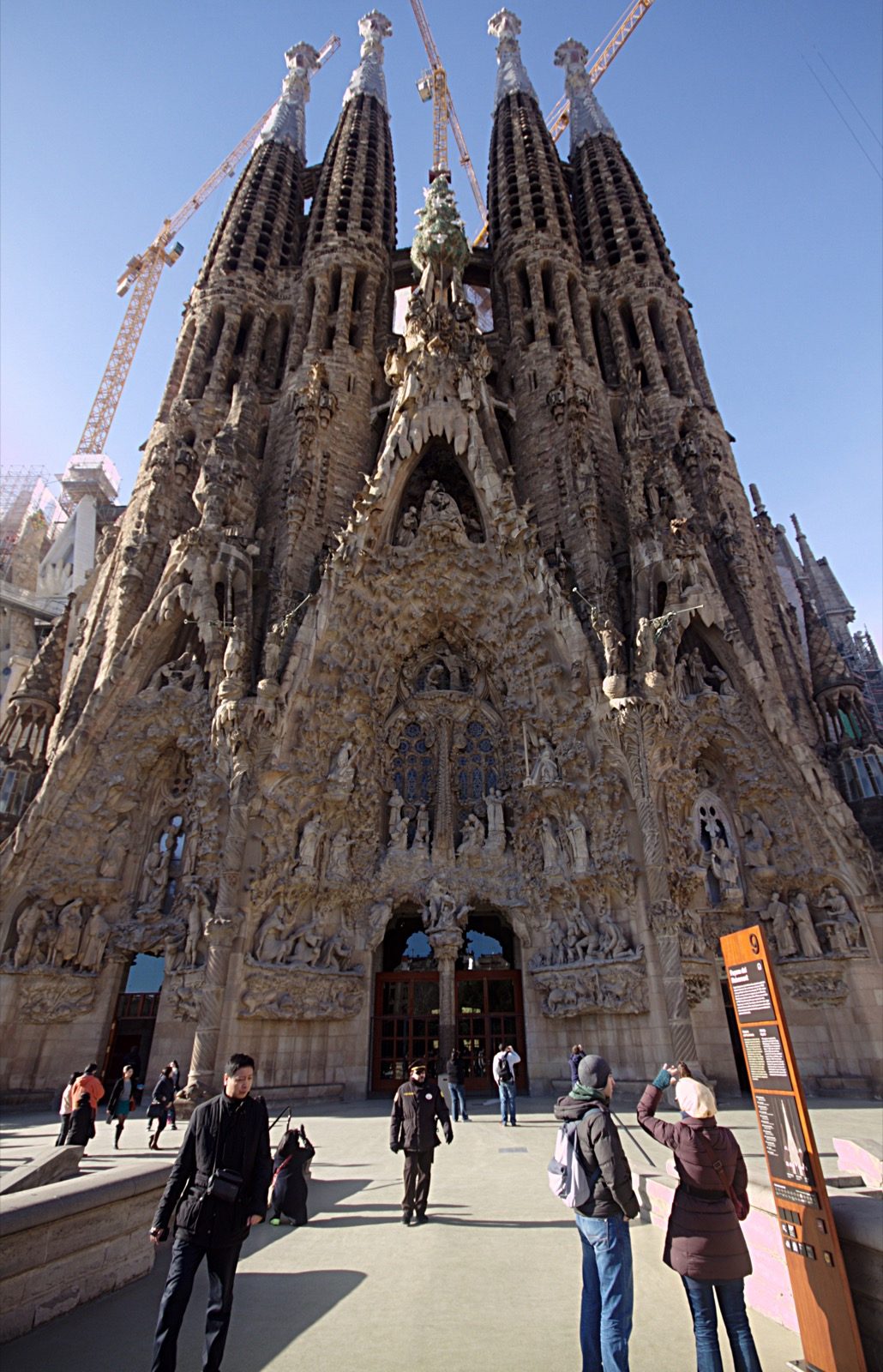 The Nativity Façade of Sagrada Família, densely carved with naturalistic sculpture of plants, animals, and biblical figures, the section of the basilica completed largely under Antoni Gaudí's supervision.